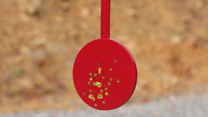 Red self-healing polymer reactive target with yellow color flare to indicate recent hits.